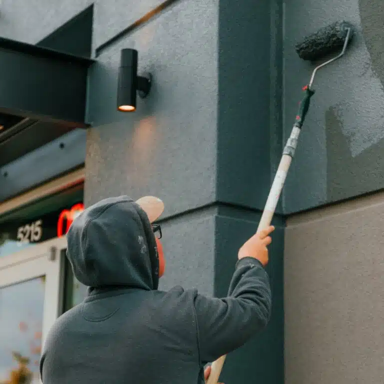 commercial painter repainting the wall Paintmaster Services
