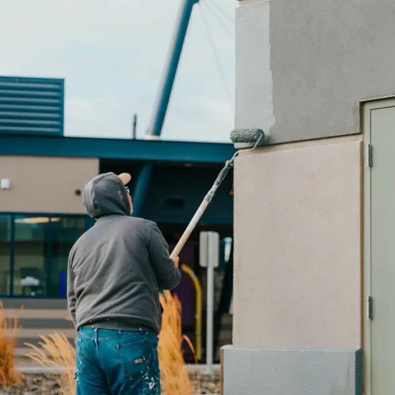 commercial painter painting the wall Paintmaster Services