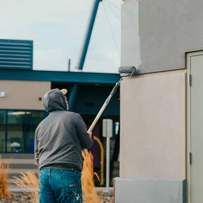 experienced commercial painter paints the wall Paintmaster Services