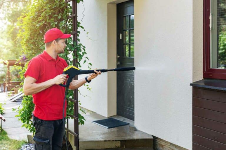 man clearing and cleaning the home's exterior Paintmaster Services Inc.