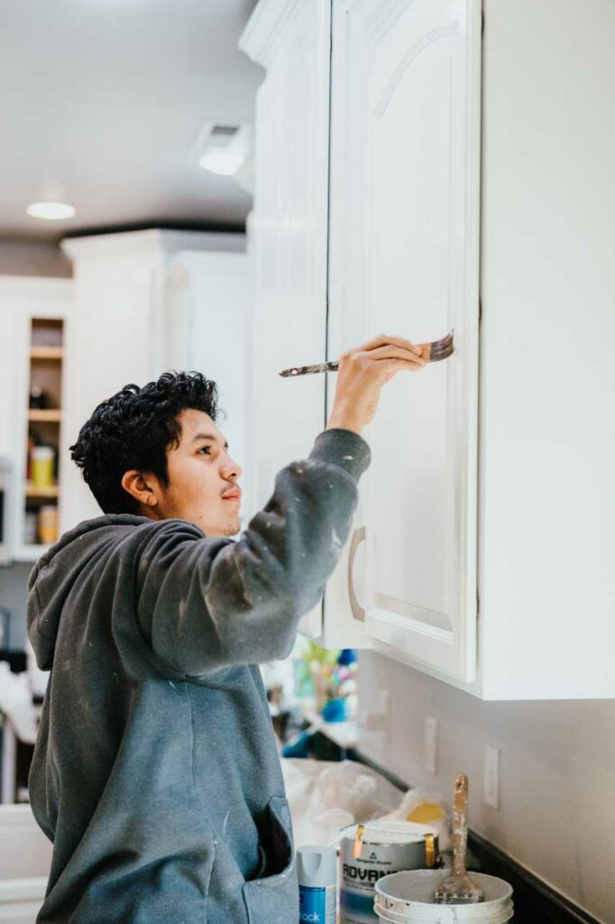 professional kitchen cabinet painters working on a project Paintmaster Services