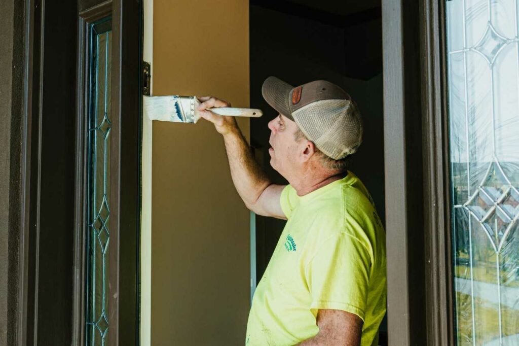 skilled painter painting the walls of a house Paintmaster Services