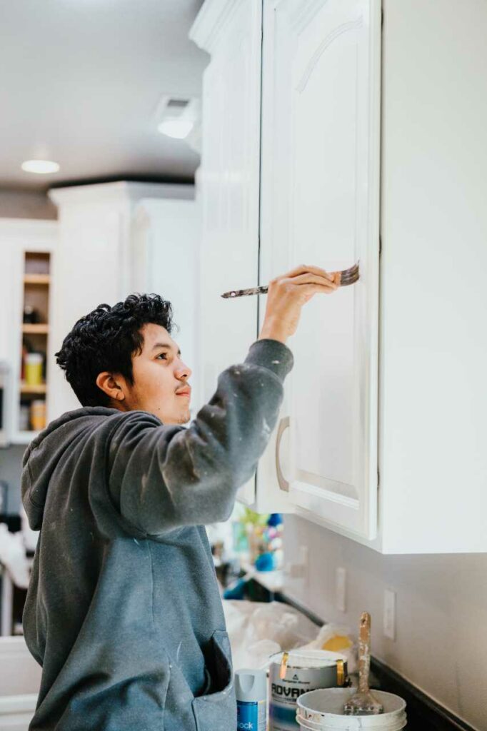 skilled painter doing kitchen cabinet painting Paintmaster Services