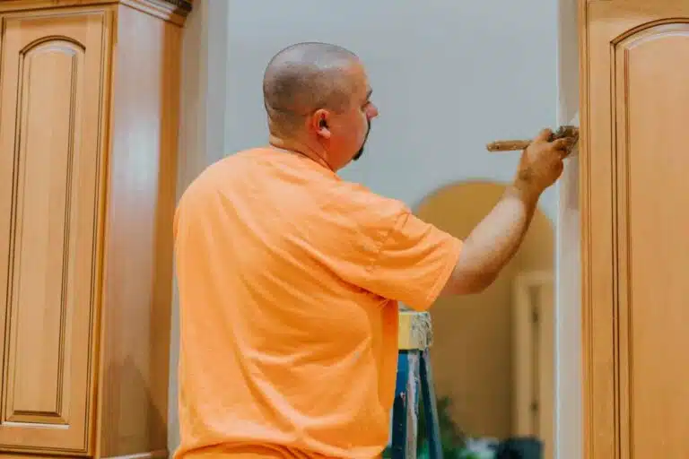professional kitchen painter painting the cabinet